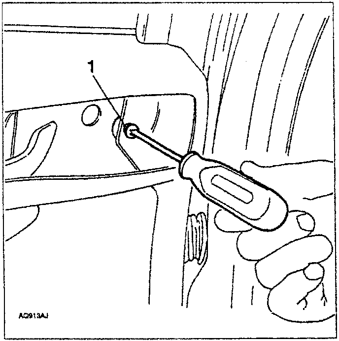 Hand using screwdriver to remove screw from door handle plate housing