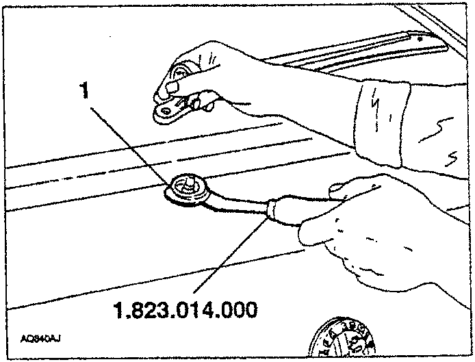Diagram showing hands using tool 1.823.014.000 to remove a rubber cap