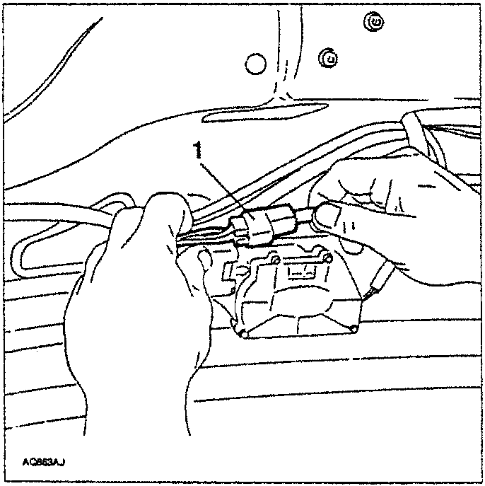 Hands disconnecting an electrical connector from a tailgate actuator.