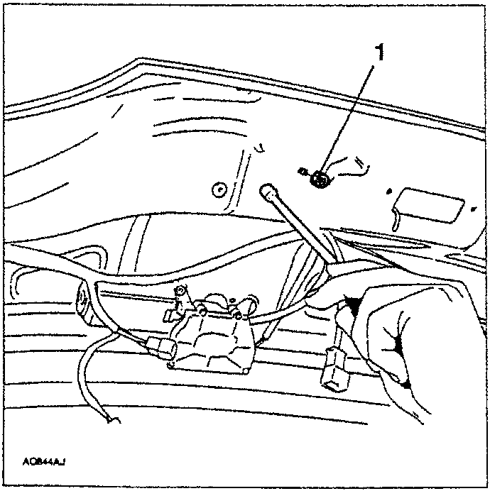 Hand using a tool to slacken a nut on the tailgate actuator.