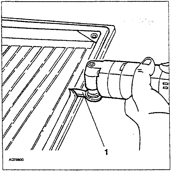 Hand using a tool to remove sealant from the edge of a rear screen glass panel.
