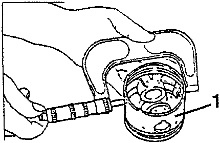 Illustration showing a hand using a caliper to measure the outside diameter of a piston, with part number 1 pointing to the piston.