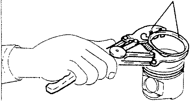Hand using tool to remove gas ring from piston