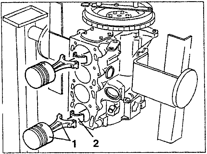Engine block with piston-rod assemblies removed, showing rod caps and bearing halves