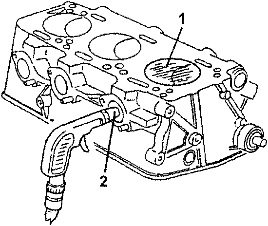 Engine block with spark plug holes and valve caps shown