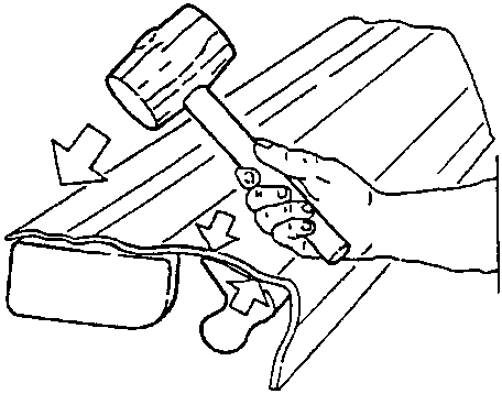 Straightening a buckled area with a hammer and dolly block