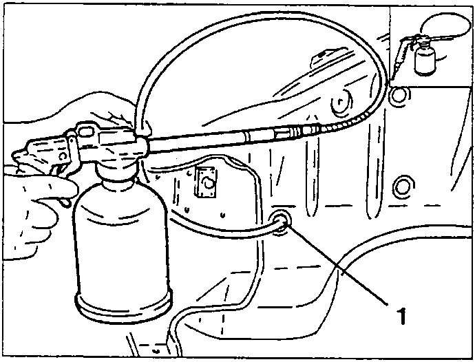 Person applying corrosion inhibitor spray to a car panel