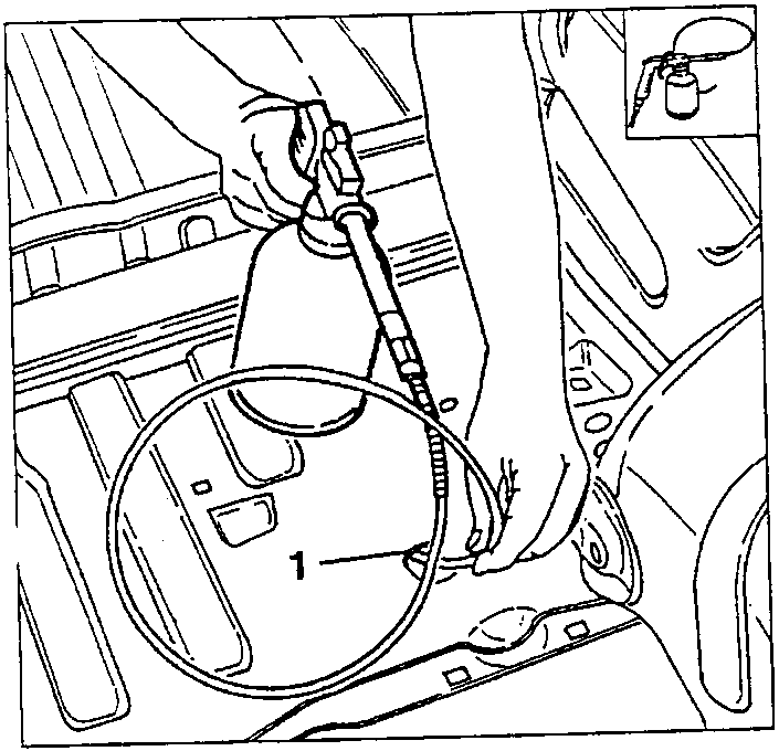 Person applying corrosion inhibitor to a car's interior panel using a spray gun.