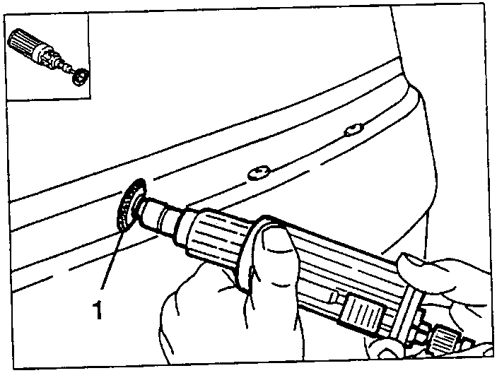 Person using a nail gun to install a nail into a car panel.