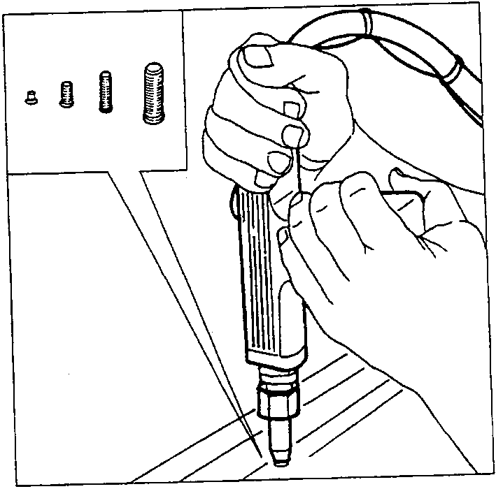Person using a nail gun to install a nail into a car panel with nails shown above.
