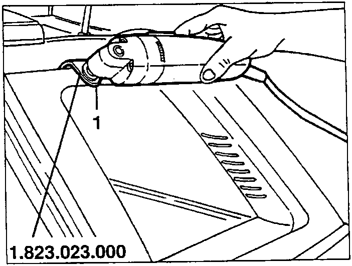 Electric shears cutting sealant on a flat surface.