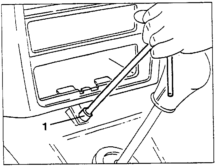 Hand using a tool to slacken a screw on the lower part of the centre console.
