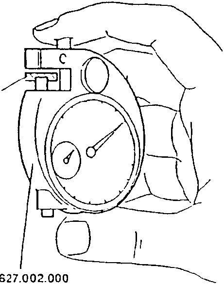 Hand holding a dial indicator with part number 1.827.002.000 (C.1.0108).