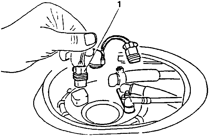 Hand disconnecting a connector from a fuel tank component