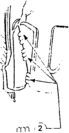 Close-up illustration showing hand positioning for welding or trimming operation with dimensional marking.