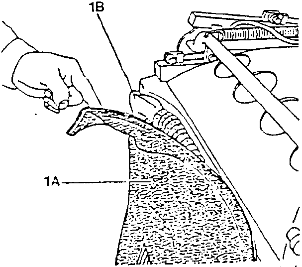 Hand winding lower part of rear covering (A) to permit access to front covering (B).