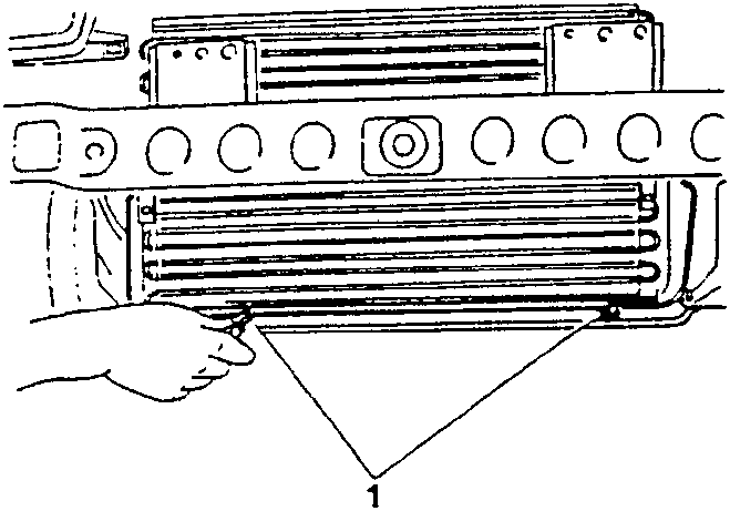 Close-up of condenser being detached from radiator with hand shown