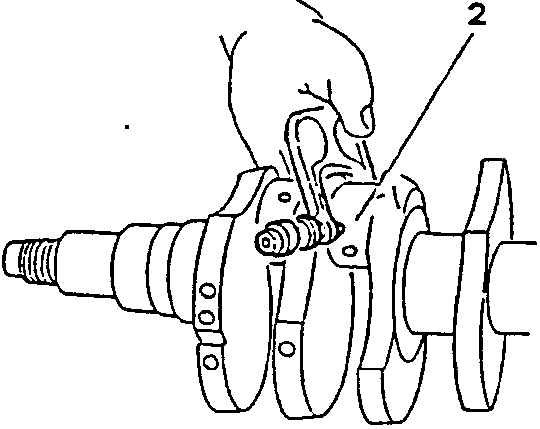 Crankshaft with hand holding tool near journal marked 2