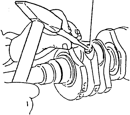 Using a punch to make a hole in oil groove plugs