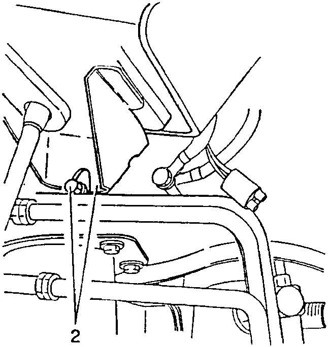 Close-up of a tool unscrewing a bolt on a car's chassis