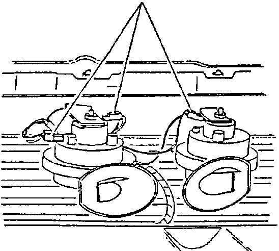 Illustration showing two horns with electrical connections being disconnected.