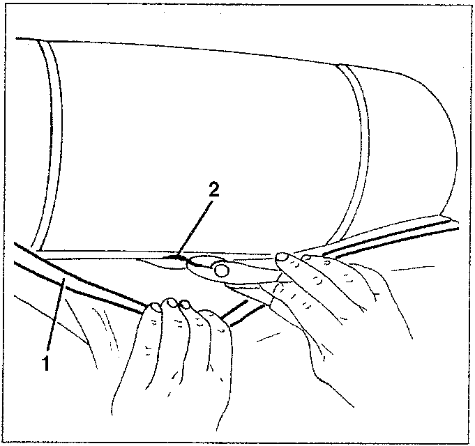 Diagram showing removal of metal clips from cover to padding