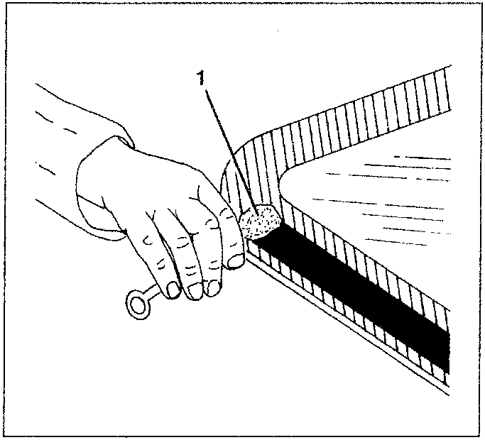 Hand applying primer to a windshield edge with an applicator.
