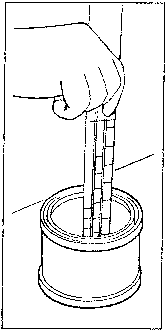 Hand stirring paint in a container with a rod scale