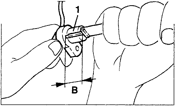 Hand holding a sensor with dimension B marked