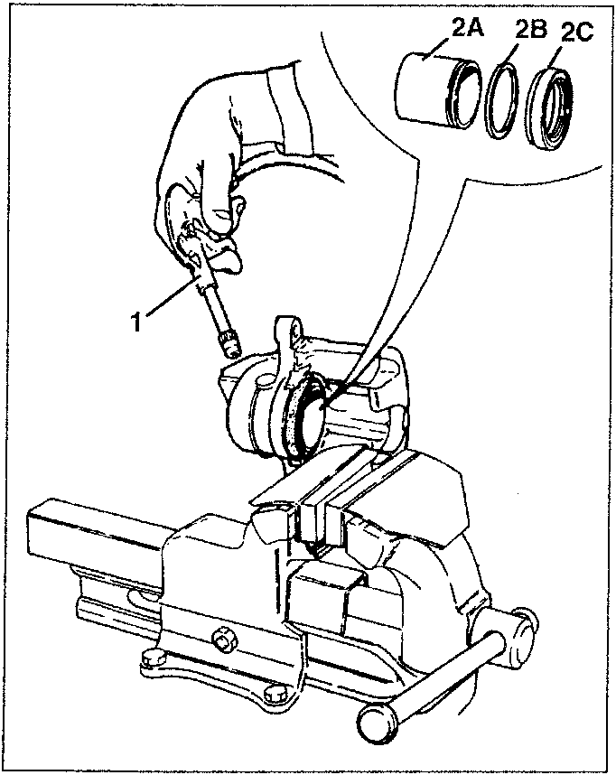 Hand using tool to remove piston, seal and protective boot from caliper