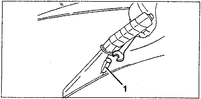 Handbrake cable being disconnected from brake caliper