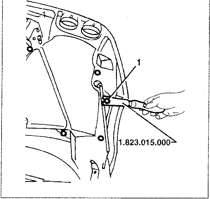 Hand using tool 1.823.015.000 to remove a plastic nail from the bonnet inner cover.