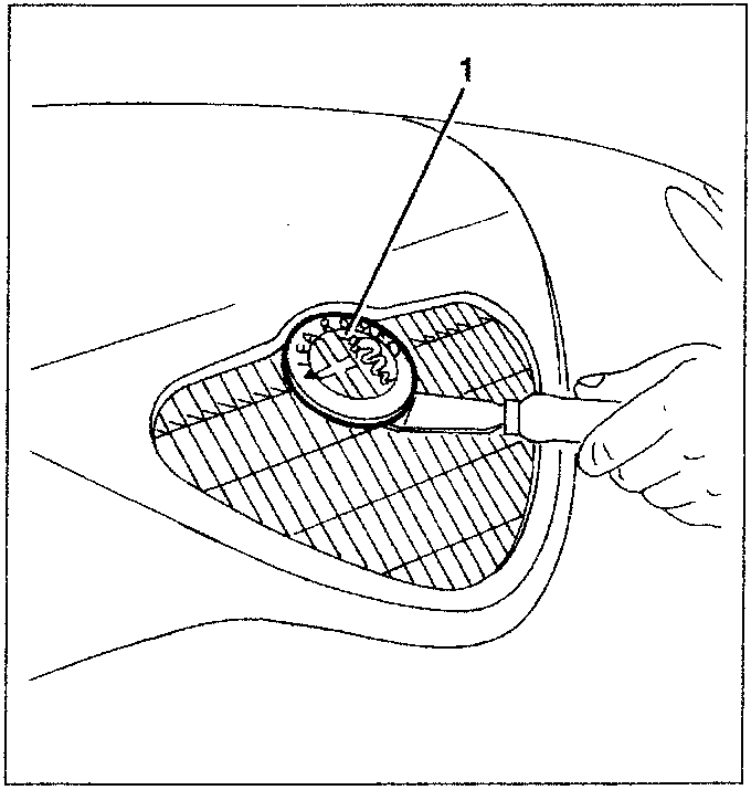 Diagram showing a hand using a tool (labeled 1) to remove a circular emblem from a car's front panel.