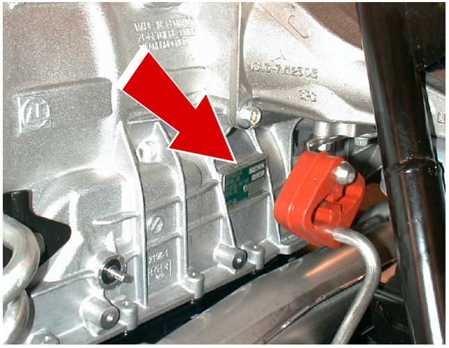 Photograph showing the automatic gearbox number plate on the LH side of the gearbox, indicated by a red arrow.
