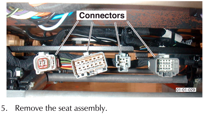 Photo showing wiring connectors under a seat base