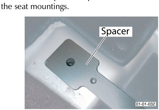 Photo showing a metal spacer plate on a seat rail