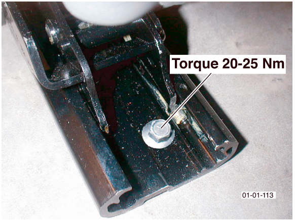 Photo of a bolt being torqued on a seat rail with label 'Torque 20-25 Nm'