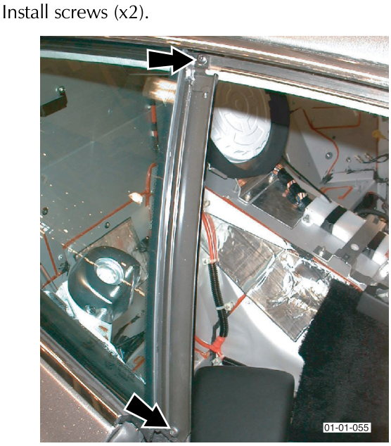Rear quarter glass installation showing screws securing the glass frame to the vehicle body