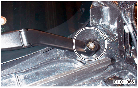 Close-up image of a wiper arm pivot point with a circled area highlighting a nut.
