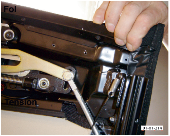A hand pulling the corner of the roof material away from the header plate, showing the internal tension mechanism.