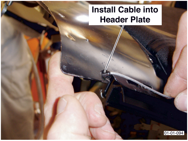 A hand installing the end of a cable into a metal header plate. Label reads Install Cable into Header Plate.