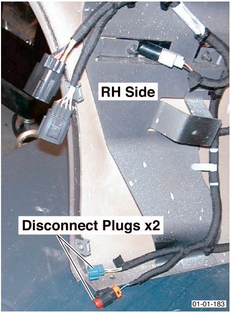 Roadwheel arch liner area on RH side showing two wiring harness plugs to disconnect