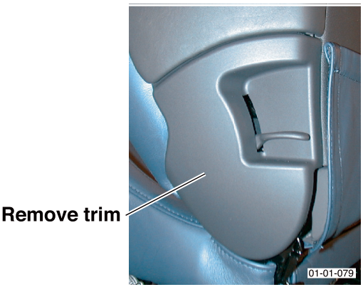 View of the lower side trim on the vehicle seat, with an arrow indicating the trim to be removed.