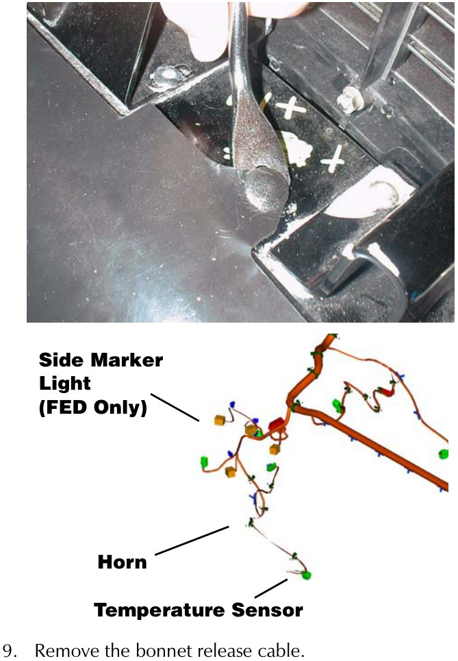 Close-up photograph of a hand using a tool to release a clip or fastener in the engine bay