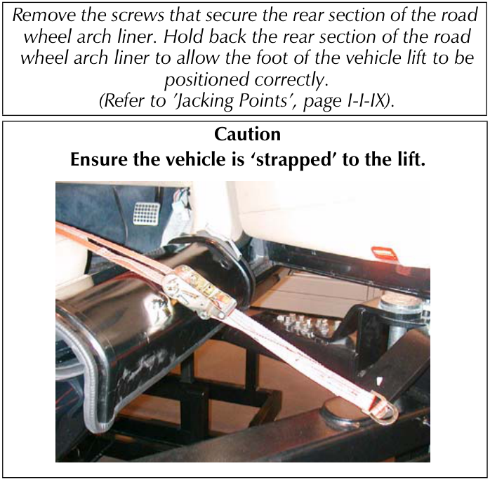 A photograph showing a strap securing a vehicle on a lift.