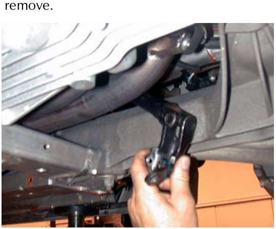 Hand pulling the intermediate steering shaft downwards to remove it