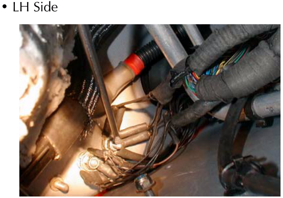 A view of the LH Side of the engine bay showing hoses, wiring, and structural components.