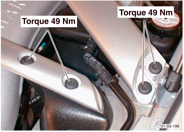 Photo showing engine bay corner braces with callout labels reading 'Torque 49 Nm' pointing to the mounting bolts.