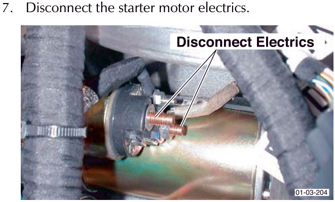 View of starter motor connection point with callout indicating Disconnect Electrics