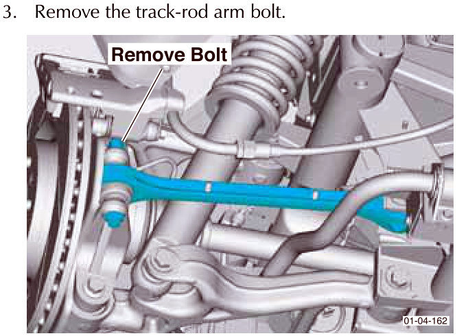 View of the track-rod arm bolt being removed from the suspension assembly